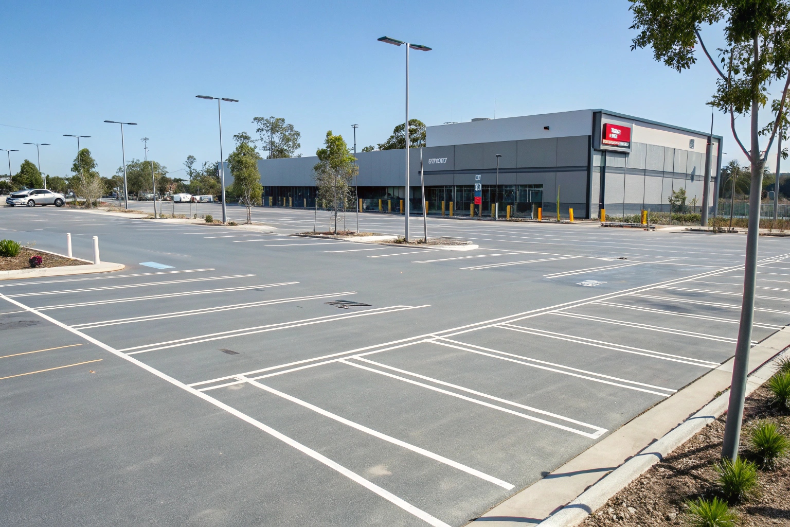 Commercial driveway coating application showing a durable epoxy surface for a business car park